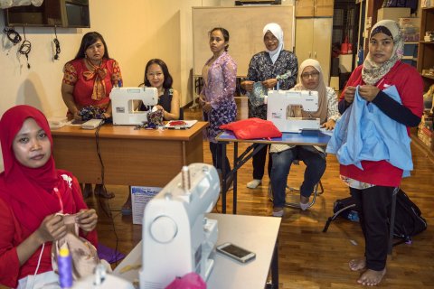 At a day centre in downtown Singapore, a group of Indonesian domestic workers find time on their one day off to learn how to sew.